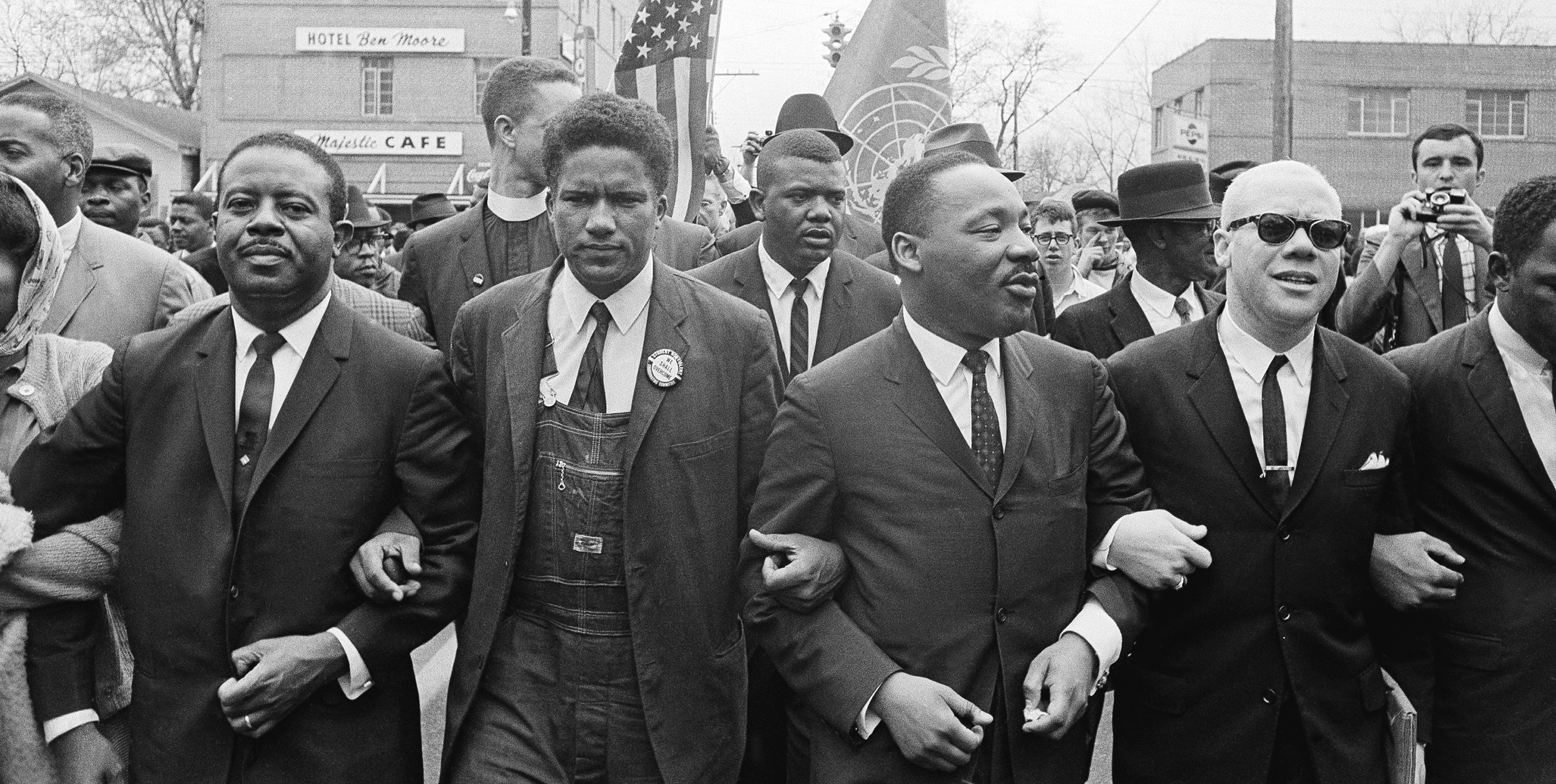 Dr. Martin Luther King, Jr. locks arms with his aides as he leads a march of several thousands on March 17, 1965 in Montgomery, Ala. (Credit: AP)