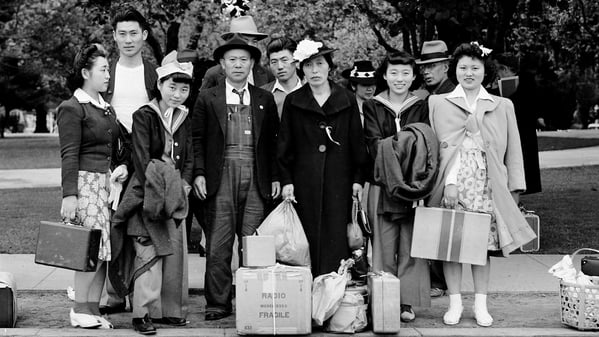 A family readies for forced evacuation during World War II.  (Photo by Dorothea Lange,)