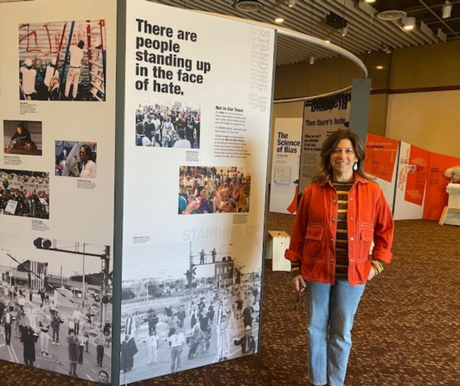 Laura Velle stands next to Bias Inside Us exhibit