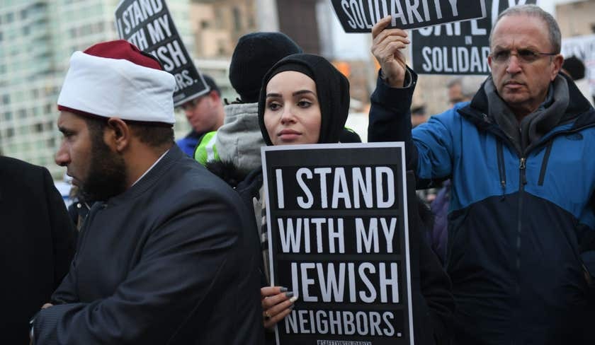 Marwa Janini, Director of the Arab American Association of New York, Safety In Solidarity sign (designed by Murad Awawdeh) at a vigil following the Monsey Stabbings. Photo by Gili Getz, December 2019.