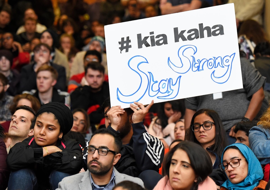 A man holds a sign at a vigil held at NYU Kimmel Center, New York. Reuters ("Kia kaha" is Maori for "stay strong".)